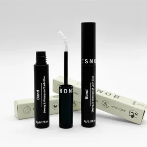 BE SNOB Lash Bond bottle with open applicator in promotional image