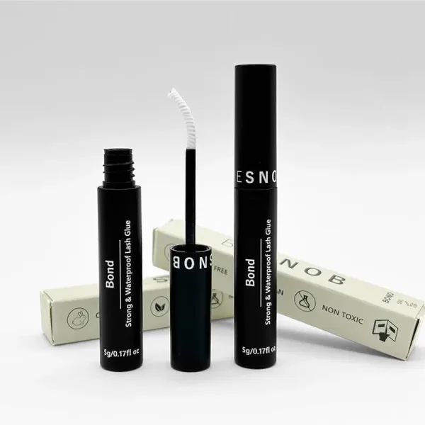 BE SNOB Lash Bond bottle with open applicator in promotional image